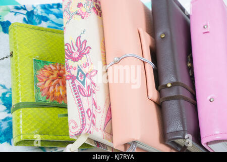 Handmade decorated notebooks and planners of different colors on white background Stock Photo