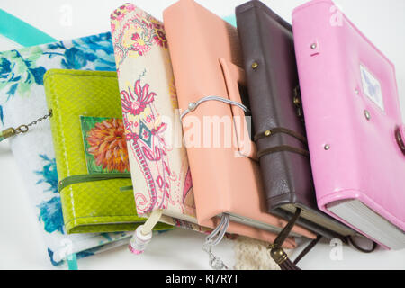 Handmade decorated notebooks and planners of different colors on white background Stock Photo