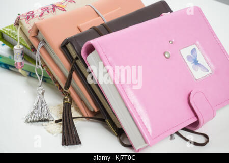 Handmade decorated notebooks and planners of different colors on white background Stock Photo
