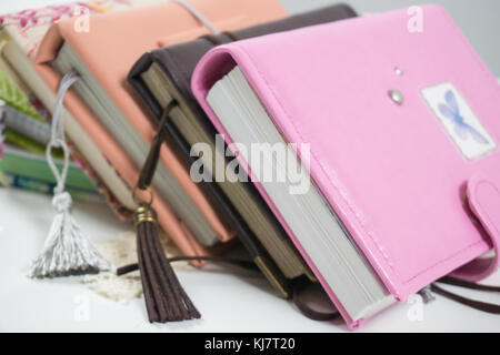 Handmade decorated notebooks and planners of different colors on white background Stock Photo