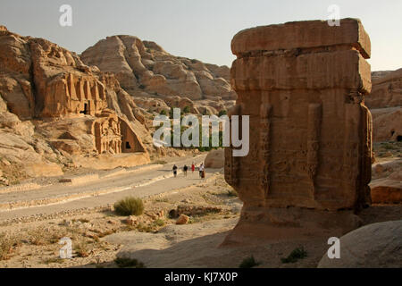 Road to the Siq, Petra. Djinn block on right, Obelisk tomb (above) and Bab As-Siq Triclinium (below) at left. Stock Photo