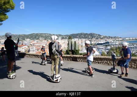 Family Tourists on Segway Scooter Tour in Suquet Old Town of Cannes overlooking La Croisette Waterfront or Seafront, Cannes, French Riviera, France