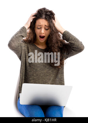 Beuaitful woman in trouble with her laptop, isolated over white background Stock Photo