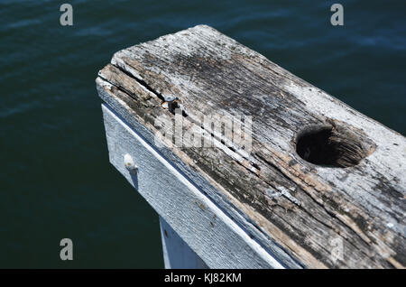 Weathered wooden handrail on wharf at The Entrance, Central Coast, NSW Stock Photo