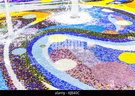 Abstract background of colorful purple, blue, green and yellow tiles mosaic in water fountain Stock Photo