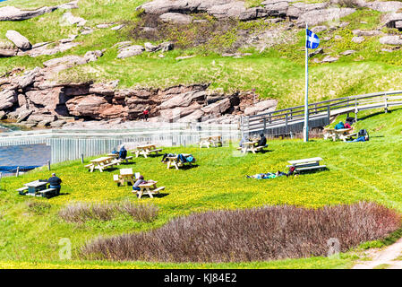 Perce, Canada - June 6, 2017: Bonaventure Island Park entrance in Gaspe Peninsula, Quebec, Gaspesie region with people sitting at picnic tables Stock Photo