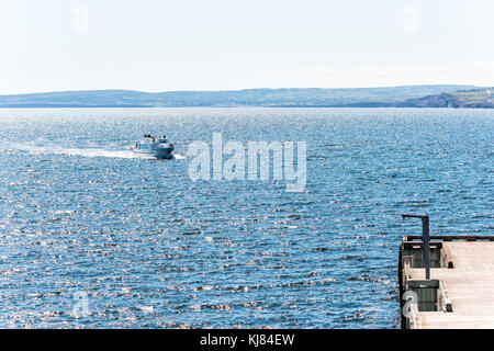 Perce, Canada - June 6, 2017: Bonaventure Island Park entrance in Gaspe Peninsula, Quebec, Gaspesie region with boat ferry swimming approaching dock p Stock Photo