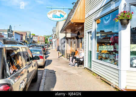 Bar Harbor, USA - June 8, 2017: People walking relaxing on sidewalk in downtown village on Mount Desert Island in New England on vacation in summer by Stock Photo