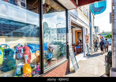 Bar Harbor, USA - June 8, 2017: People walking on sidewalk in downtown village on Mount Desert Island in New England on vacation in summer by Cadillac Stock Photo