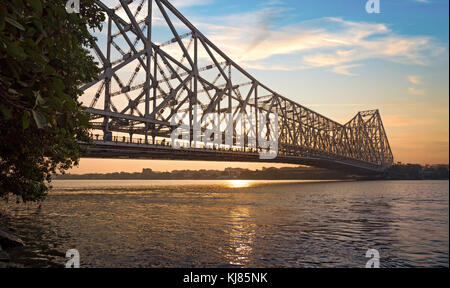 Historic Howrah bridge Kolkata at sunrise with moody sky Stock Photo