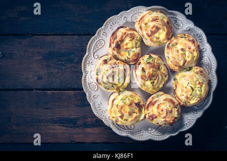 Pastry snack stuffed with ham and cheese on wooden background with blank space Stock Photo