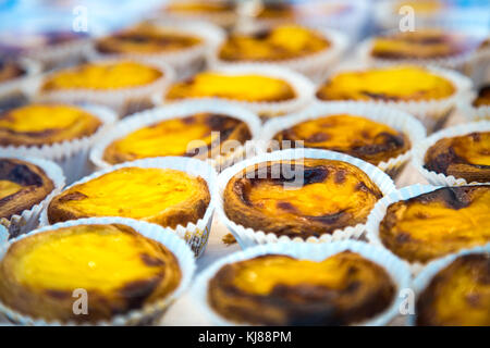 Rows of pastel de nata, traditional Portuguese pastry, at a shop Stock Photo