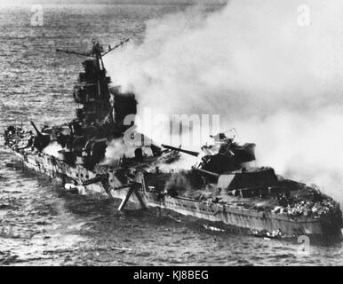 The burning Japanese cruiser Mikuma, 6 June 1942. Japanese heavy cruiser Mikuma, photographed from a USS Enterprise (CV-6) SBD aircraft during the Battle of Midway, after she had been bombed by planes from Enterprise and USS Hornet (CV-8). Note her shattered midships structure, torpedo dangling from the after port side tubes and wreckage atop her number four eight-inch gun turret. 6 June 1942 - Battle of Midway Stock Photo