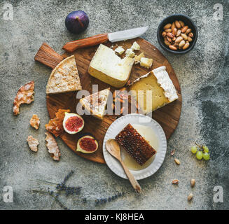 Flat-lay of cheese assortment, figs, honey and nuts Stock Photo
