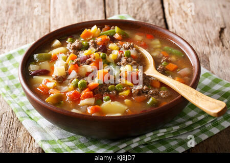 Tomato soup with ground beef and vegetables close-up in a bowl on the table. horizontal Stock Photo