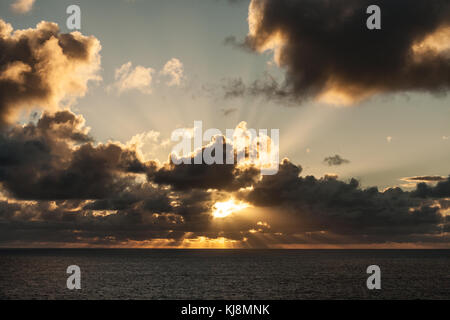 Suns Rays Burst through Dark clouds Stock Photo
