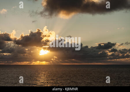 Suns Rays Bursting through Dark clouds Stock Photo