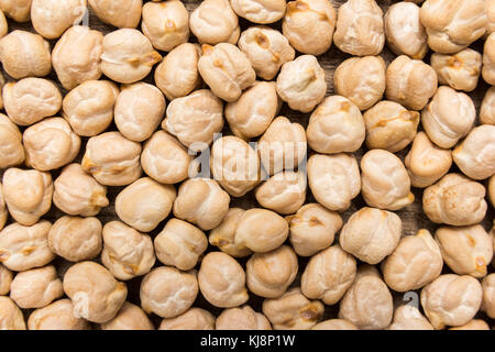 Cicer arietinum is scientific name of Chickpeas legume. Also known as Garbanzo bean, Chick Peas or Grao de Bico. Closeup of grains, background use. Stock Photo