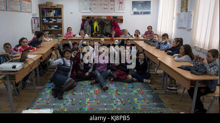 DEVESELU, Romania (Nov. 15, 2017) Cmdr. Lydia Haase, center, the senior medical officer on board Aegis Ashore Missile Defense System (AAMDS) Romania, poses for a photo with students from Deveselu Elementary School after discussing healthy habits during a community relations project. Naval Support Facility Deveselu and AAMDS Romania are co-located in with the Romanian 99th Military Base and play a key role in ballistic missile defense in Eastern Europe. Stock Photo