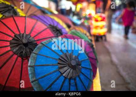Colorful handmade paper umbrellas at traditional street night market in Luang Prabang, Laos.