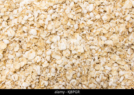 Avena Sativa is scientific name of Oat cereal flake. Also known as Aveia or Avena. Closeup of grains, background use. Stock Photo