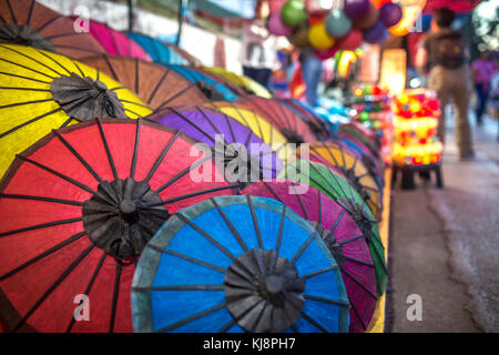 Colorful handmade paper umbrellas at traditional street night market in Luang Prabang, Laos.
