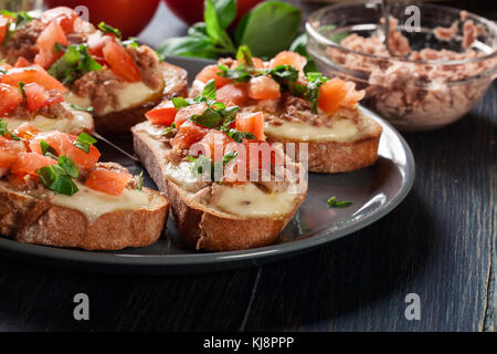 Appetizer bruschetta with tuna, mozarella cheese and tomatoes. Italian cuisine Stock Photo