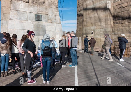 Tourist walking over the Brooklyn Bridge
