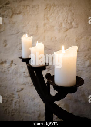 Beautiful vase and candles on rustic silver candelabra in stylish home wedding Stock Photo