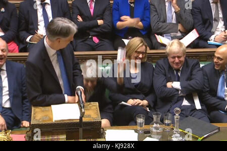 Chancellor Philip Hammond is given some cough sweets by Prime Minister Theresa May as he delivers his Budget in the House of Commons, London. Stock Photo