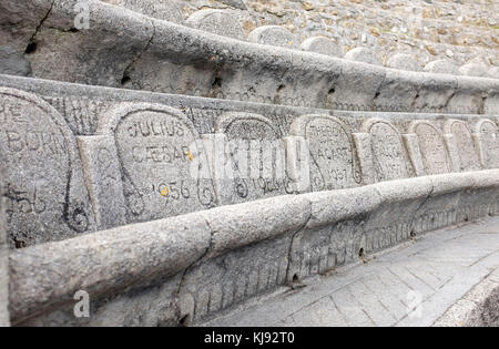 Names of plays on the seats at the famous Minack Theatre built into the cliffs at Porthcurno in Cornwall and was the brainchild of Rowena Cade Stock Photo