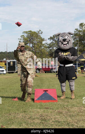 Sgt. Rocky, 3rd Infantry Division's mascot, plays a bean bag toss game with Pfc. Trent Kelly, a Dog Face Soldier assigned to 24th Ordnance Company, 87th Combat Sustainment Support Battalion, 3rd Infantry Division Sustainment Brigade, November 14, 2017 during a Family Fun Day at Fort Stewart, Ga. This event took place during Marne Week, a celebration for Soldiers to participate in recreational activities while honoring the division's service to the nation. This month marks the centennial anniversary of the Marne Division. (U.S. Army photo by Sgt. Caitlyn Smoyer/Released) Stock Photo