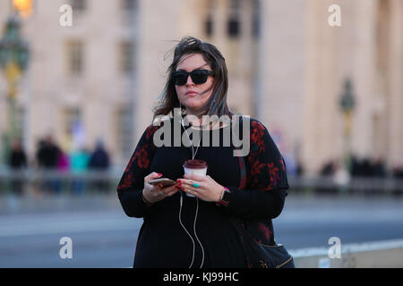 Westminster. London, UK. 22nd Nov, 2017. Tourist on Westminster Bridge on a windy but warm evening in the capital Credit: Dinendra Haria/Alamy Live News Stock Photo