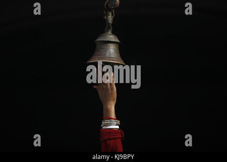 Janakpur, Nepal. 23rd Nov, 2017. A hand of a devotee ringing a holy bell is pictured during the marriage anniversary of Lord Ram and Sita during Bibaha Panchami at Janaki Temple in Janakpur, some 400km southeast from Kathmandu in Nepal on Thursday, November 23, 2017. The temple is filled with thousands of people from all across Nepal and India. The temple is decorated as a real marriage. Credit: Skanda Gautam/ZUMA Wire/Alamy Live News Stock Photo