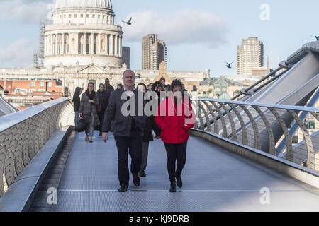 London, UK. 23rd Nov, 2017. People struggle with the blustery cold weather conditions walking on Millenium Bridge London with winds likely to gust up to 60mph in some places  Credit: amer ghazzal/Alamy Live News Stock Photo