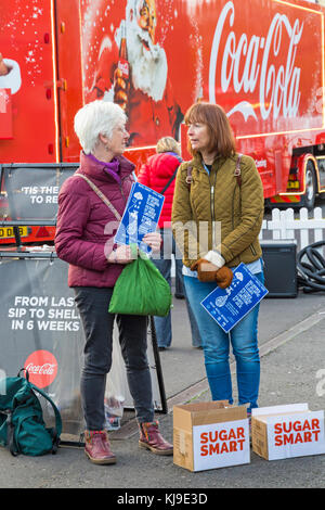 Bournemouth, Dorset, UK. 23rd Nov, 2017. Sugar campaigners protest at the arrival of the Christmas Coca Cola truck in Bournemouth. The Sugar Smart campaign run by Jamie Oliver and the charity Sustain help to reduce the amount of sugar we consume. Members of Poole and Bournemouth Sugar Smart campaign believe sugary drinks contribute to child obesity. Volunteers, calling themselves tooth fairies, stand by the truck handing out free water and toothbrushes. Credit: Carolyn Jenkins/Alamy Live News Stock Photo