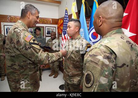 Paju, South Korea. 23rd November, 2017. U.S. Army Gen. Vincent Brooks, U.S. and U.N. Forces Korea commander, left, presents the Army Commendation medal to U.S. and South Korean soldiers during a Thanksgiving Day ceremony at Camp Bonifas on the Demilitarized Zone November 23, 2017 in Paju, South Korea. The soldiers were recognition for their efforts in rescuing a North Korean defector on November 13th. Credit: Planetpix/Alamy Live News Stock Photo