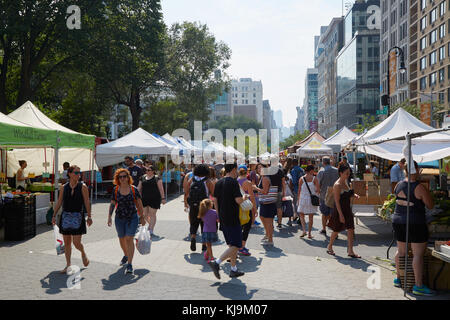 Union Square greenmarket with people in a sunny day in New York. The market is held four days each week. Stock Photo