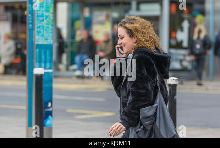 Woman use of mobile phone in city at night Stock Photo - Alamy
