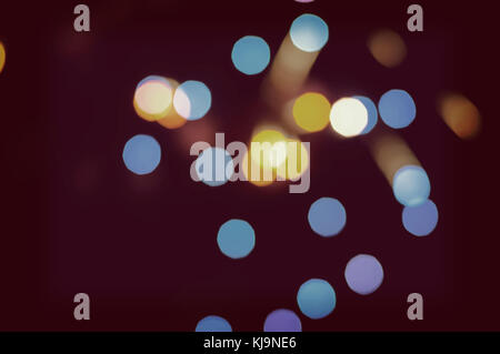 Christmas background. Festive abstract holidays background with bokeh defocused lights and stars, toned. Lilac, blue, yellow, white, purple, violet co Stock Photo