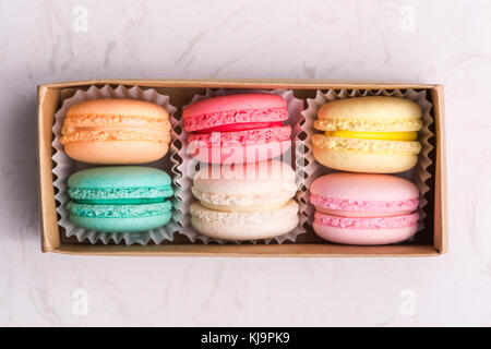 Set of different french cookies macaroons in a paper box. Top view. Stock Photo