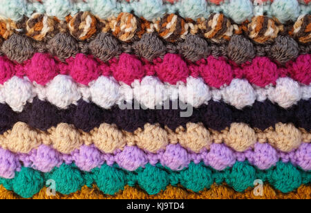 Horizontal multi-coloured stripes of bobble crochet stitches as abstract background texture Stock Photo