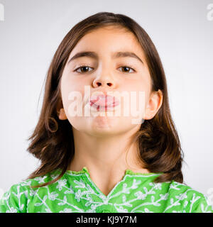 Portrait of a little girl making a funny expression Stock Photo