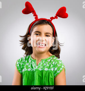 Studio portrait of a little girl wearing a headband with hearts Stock Photo