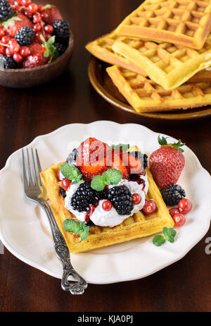 Traditional Belgium waffles with berry fruits and ice cream on wooden ...