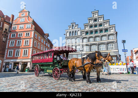 LUNEBURG, GERMANY - MAY 28, 2016: Horse-drawn coach on the historic square in Luneburg Stock Photo