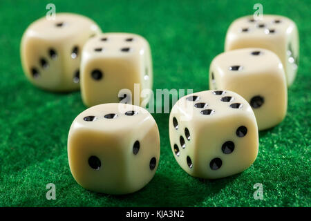 Six dices on a green felt table Stock Photo