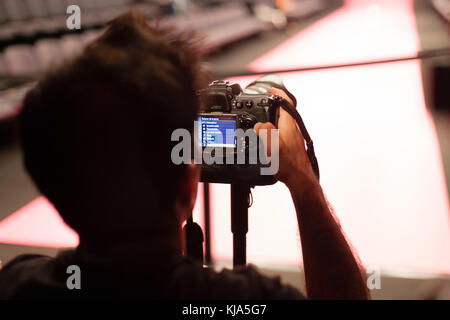 Photographer setting camera Stock Photo
