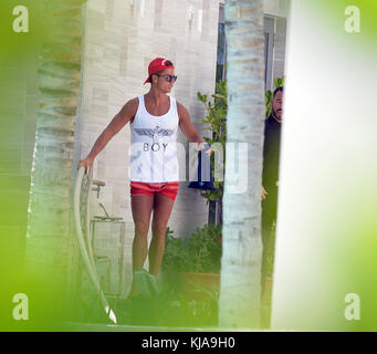 MIAMI BEACH, FL - JUNE 24: Cristiano Ronaldo seen in south beach wearing red shorts, a shirt thats says BOY, and a matching red hat thats says SWAGGER . Cristiano Ronaldo dos Santos Aveiro GOIH (born 5 February 1985), known as Cristiano Ronaldo, is a Portuguese professional footballer who plays for Spanish club Real Madrid and the Portugal national team. He is a forward and serves as captain for Portugal on June 24, 2015 in Miami Beach, Florida.   People:  Cristiano Ronaldo Stock Photo