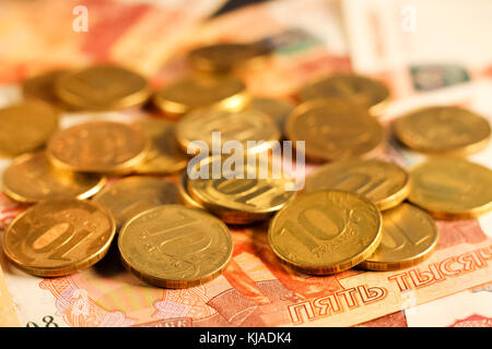 Set of russian ruble coins laying on russian banknotes. Russian currency close up. Financial concept. Stock Photo